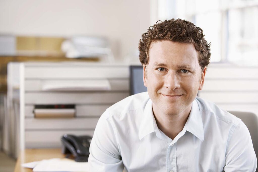 Portrait,Of,Smiling,Young,Businessman,In,Office