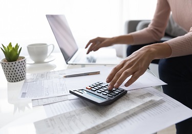 Close,Up,Young,Woman,Calculating,Monthly,Domestic,Utility,Bills,Using