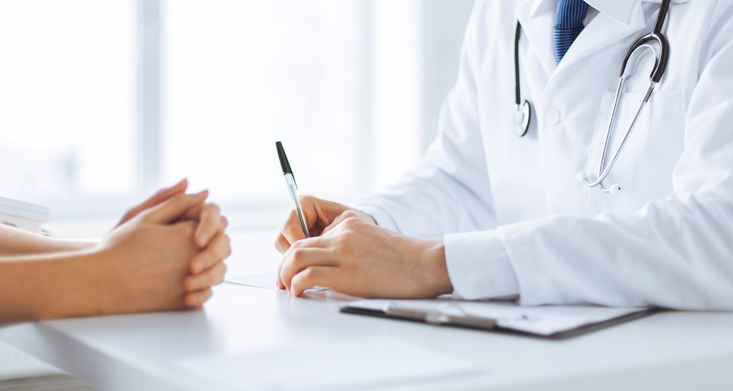 Close,Up,Of,Patient,And,Doctor,Taking,Notes